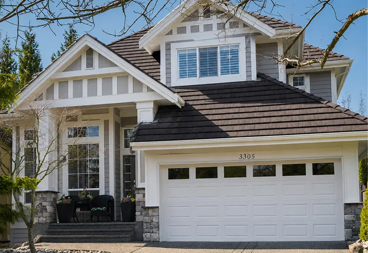 Vibrant, newly coated exterior siding and updated garage door trim by ColorWorks Painting Calgary