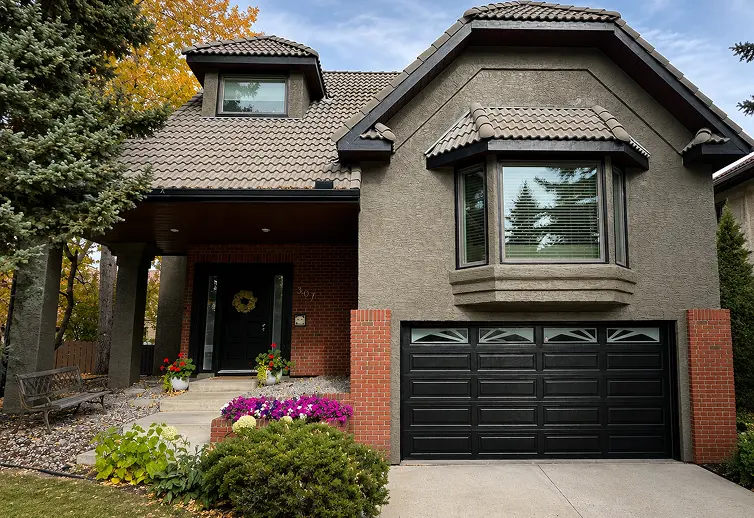 Restored stucco home with modern exterior paint finish in Calgary