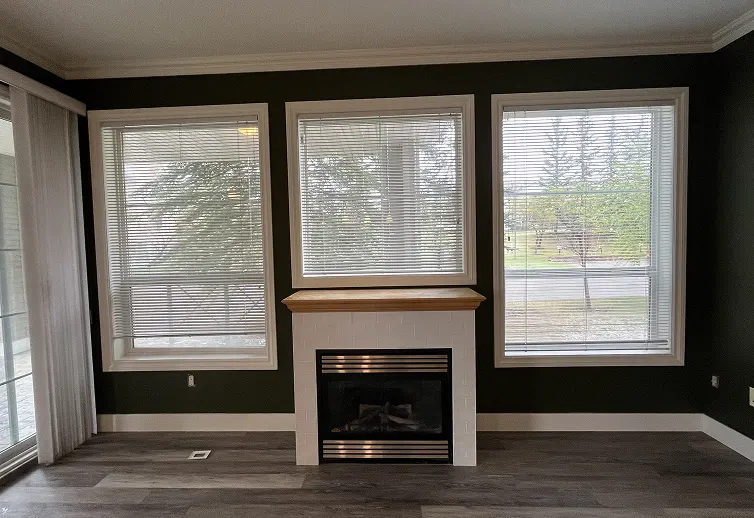 Interior room before painting with faded wall color, visible wear, and outdated finish