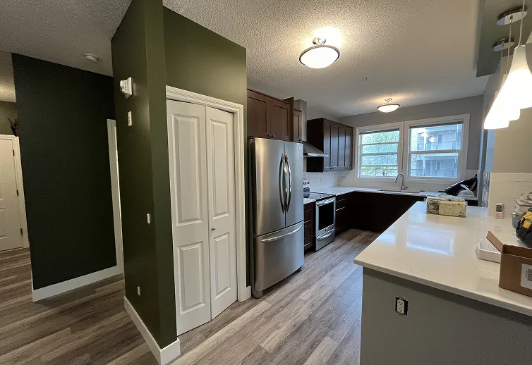 Residential interior space before painting showing stained walls and preparation for renovation