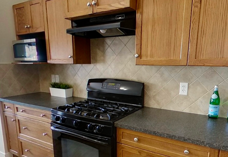 Kitchen cabinets before painting showing worn finish, outdated color, and signs of daily wear