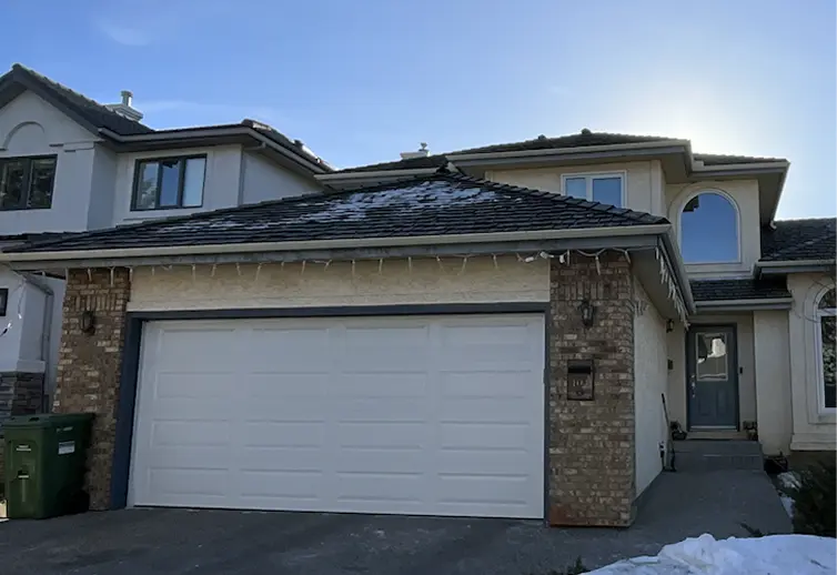 Weathered stucco exterior before professional stucco painting services in Calgary