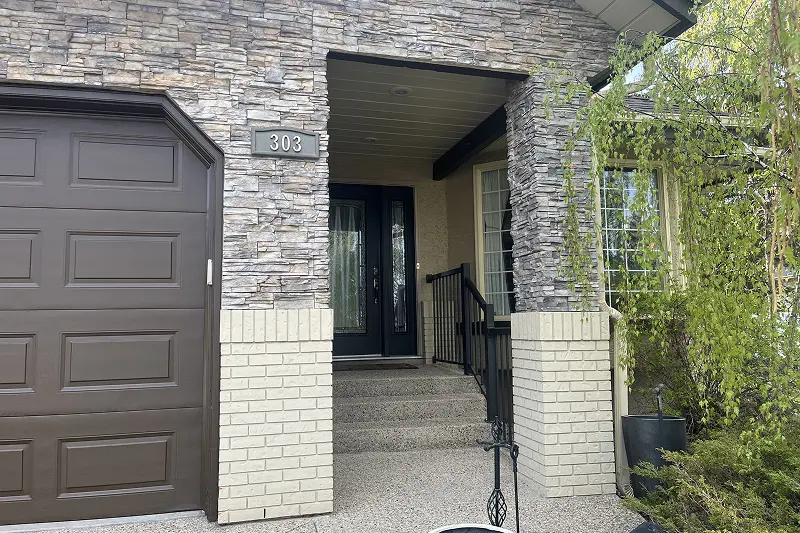 Freshly painted residential home exterior in Christie Estates, Calgary, with a smooth and durable weather-resistant finish