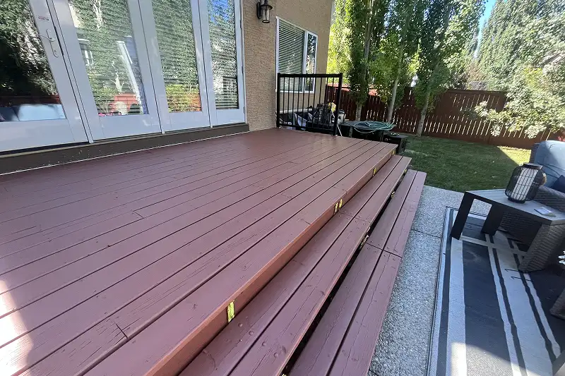 Professional fence and deck staining in Aspen Woods, Calgary, enhancing the beauty and durability of outdoor wood surfaces