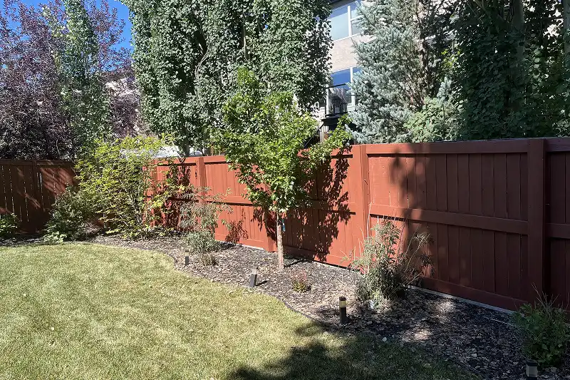 Beautifully stained outdoor deck and fence in Aspen Woods, Calgary, with a durable finish designed for Alberta’s climate