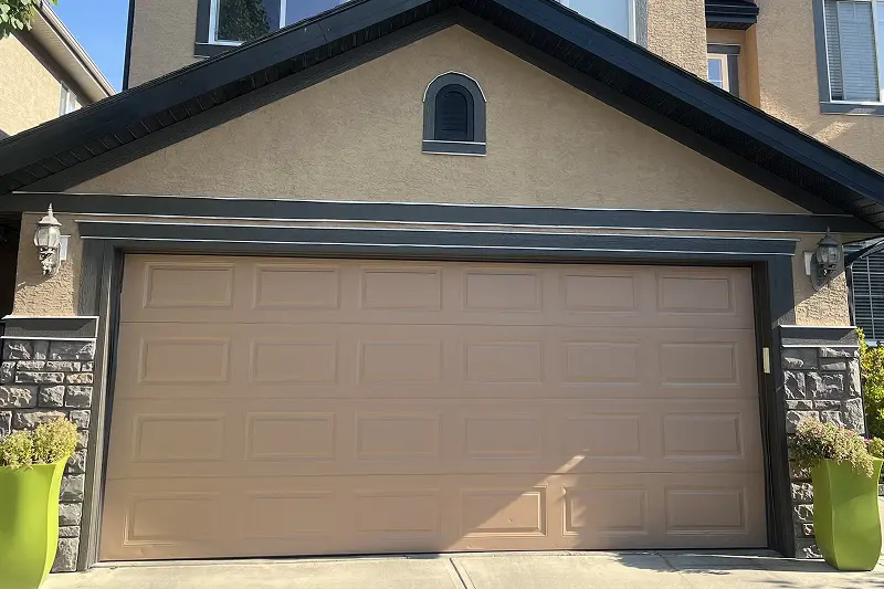 Completed exterior trim and entry door painting project in Tuscany, Calgary, showcasing expert craftsmanship and enhanced home appearance