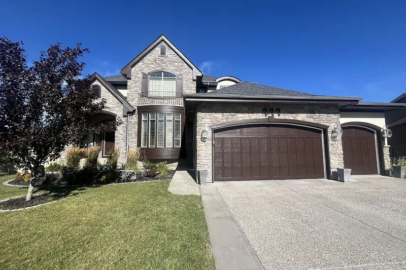 Professional exterior trim and front door painting in Wentworth, Calgary, featuring a refreshed finish and enhanced curb appeal