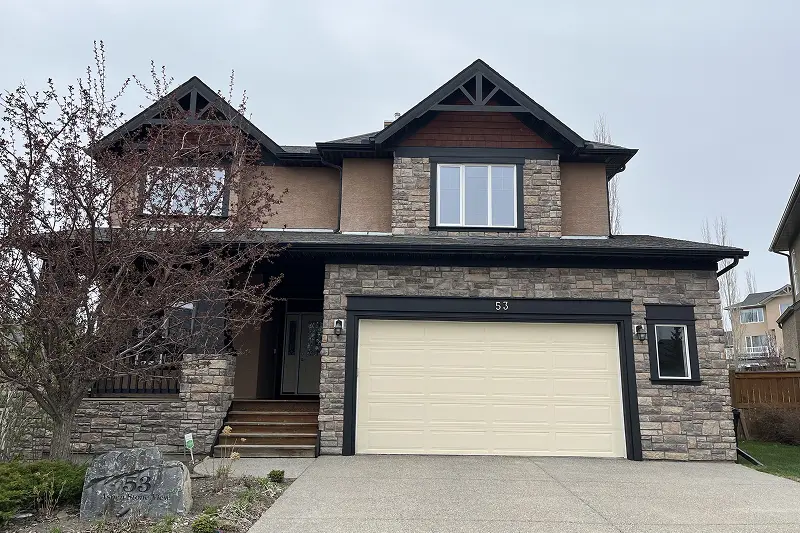 Professional exterior trim and door painting project in Aspen Woods, Calgary, enhancing the home's curb appeal and exterior finish