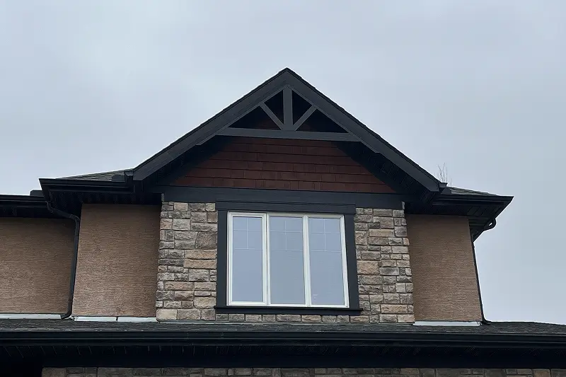 Freshly painted front door and exterior trim on a residential property in Aspen Woods, Calgary, with a clean and modern look