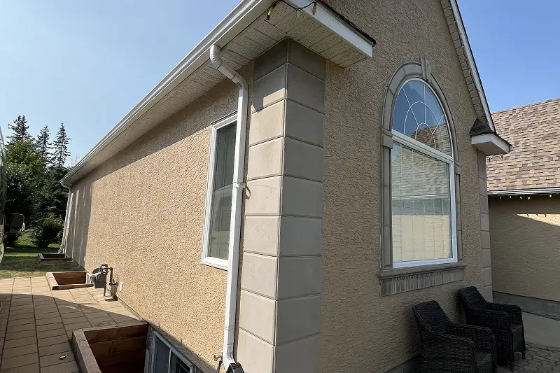 Freshly painted residential home exterior in Patterson, Calgary, with a durable and weather-resistant finish