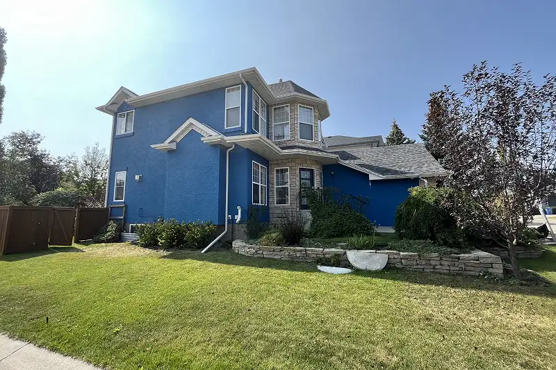 Freshly painted residential home exterior in Strathcona Park, Calgary, featuring expert workmanship and durable protection