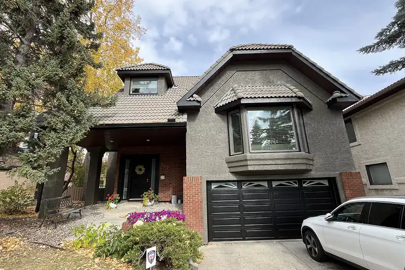 Professional full exterior house painting in Coach Hill, Calgary, featuring a refreshed look and enhanced curb appeal