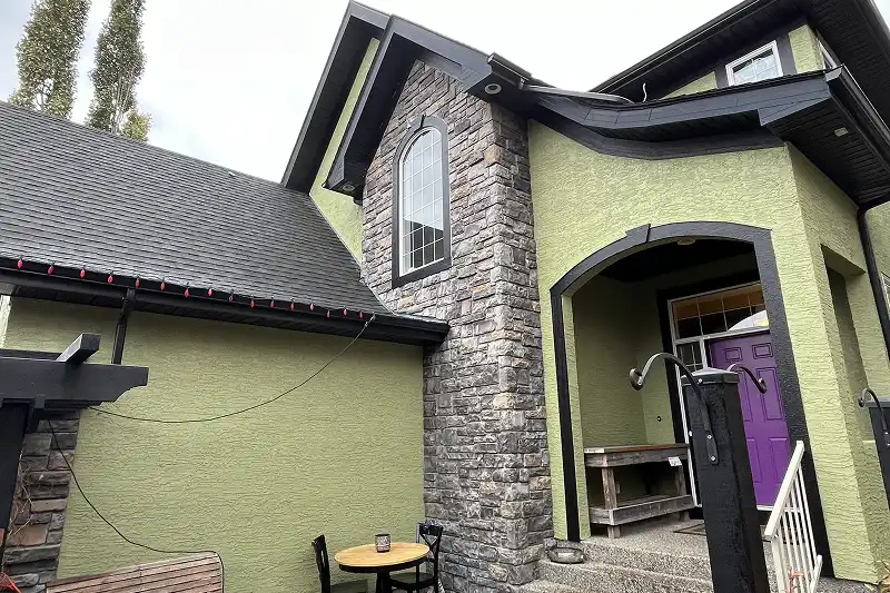 Freshly painted residential home exterior in Arbour Lake, Calgary, with a durable weather-resistant finish and expert workmanship