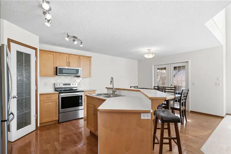 Residential kitchen interior painting by Color Works Painting, seamlessly blending neutral wall tones with natural wood cabinetry.