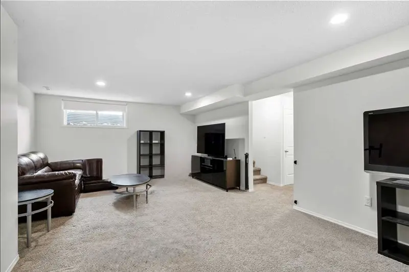 Spacious finished basement interior painting by Color Works Painting, utilizing a bright, cohesive color scheme to maximize lower-level light.