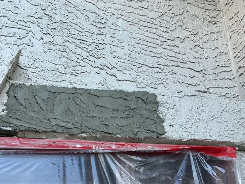 Stucco patch repair and surface restoration before exterior painting