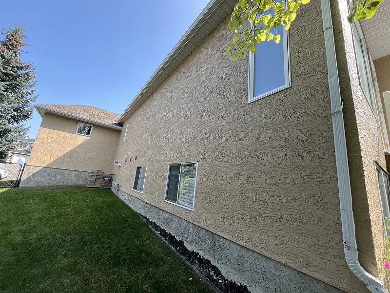 Calgary stucco painting experts applying professional coatings to a residential stucco exterior